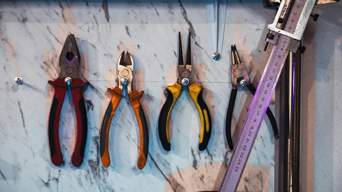 A bunch of tools hanging on a wall